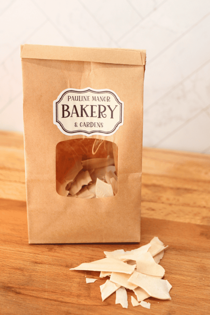 bag of dehydrated sourdough starter with flakes in front on a wooden butcher block counter