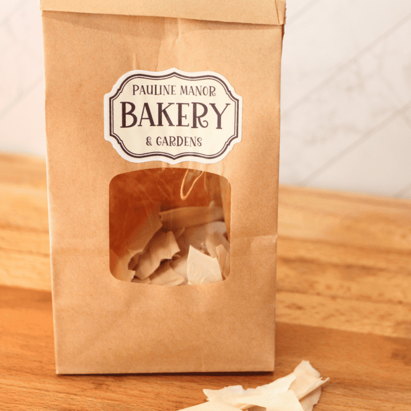 bag of dehydrated sourdough starter with flakes in front on a wooden butcher block counter